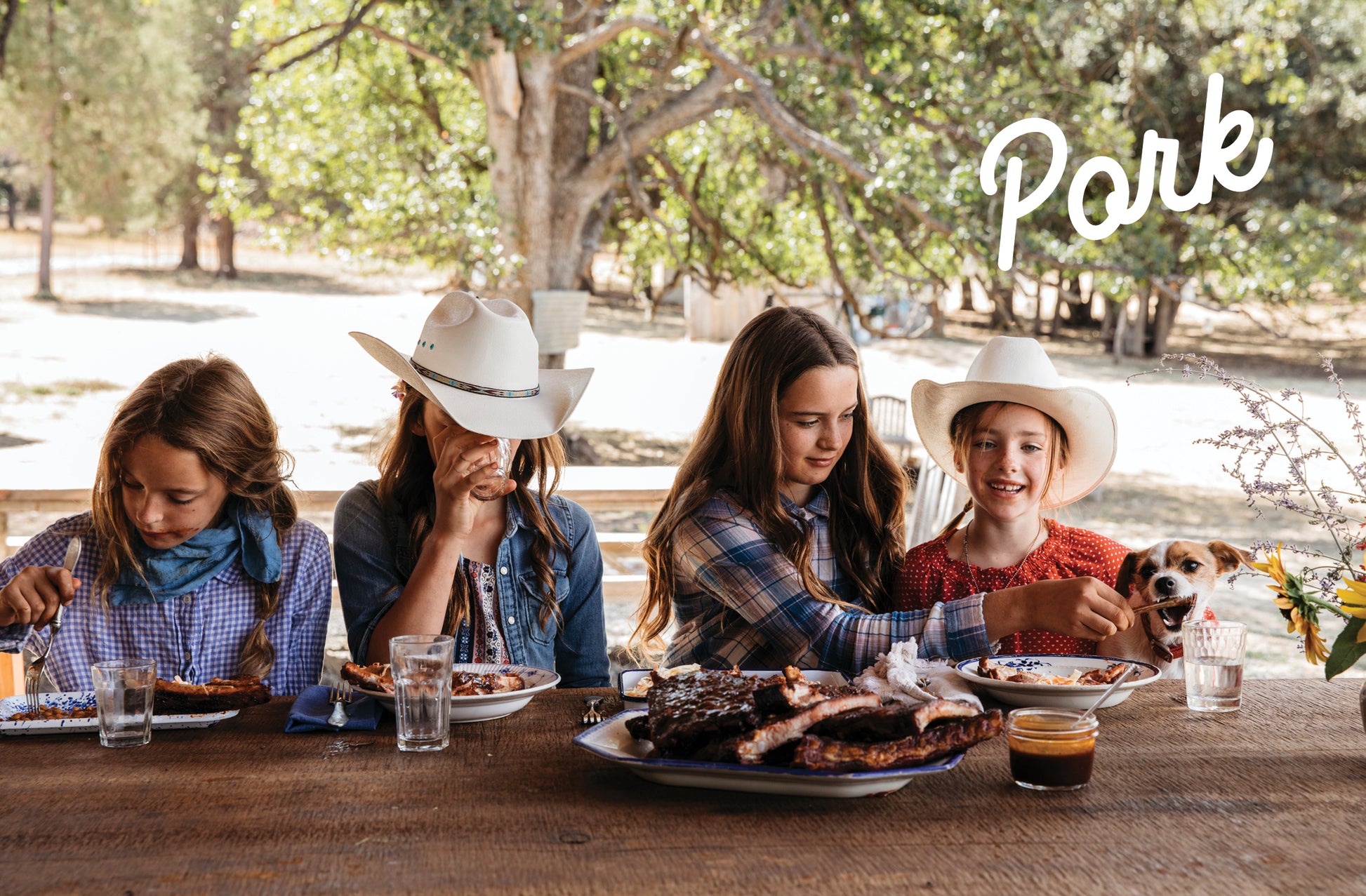 Five Marys Ranch Raised' with Four people sitting at a table outdoors, enjoying a meal with 'Pork' branding.