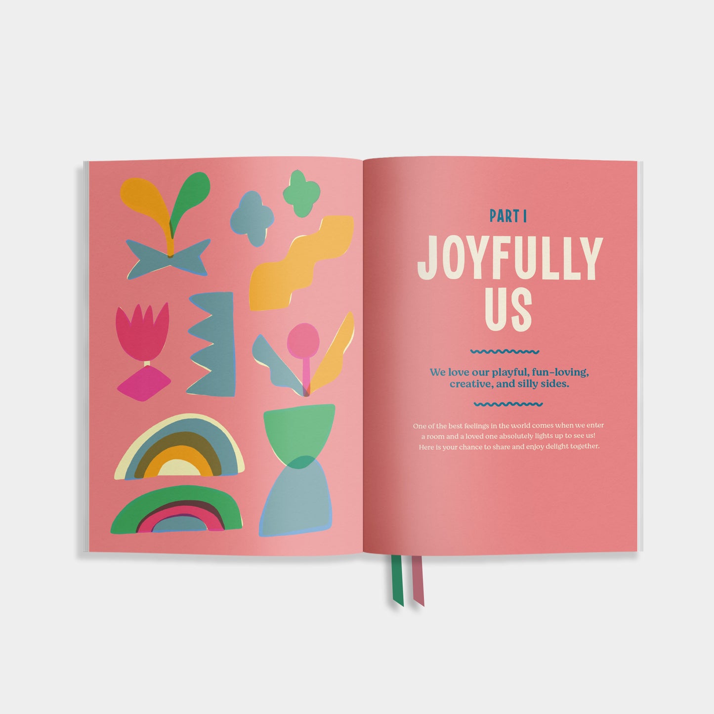 Open book view of 'Uniquely Us' with colorful abstract designs on a pink background