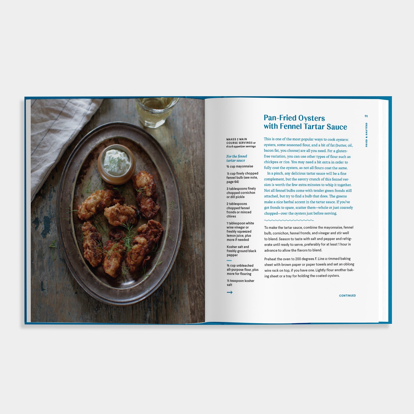 Open cookbook of Essential Shellfish Collection showing a plate of par-fried oysters with fennel tartar sauce on a wooden surface.