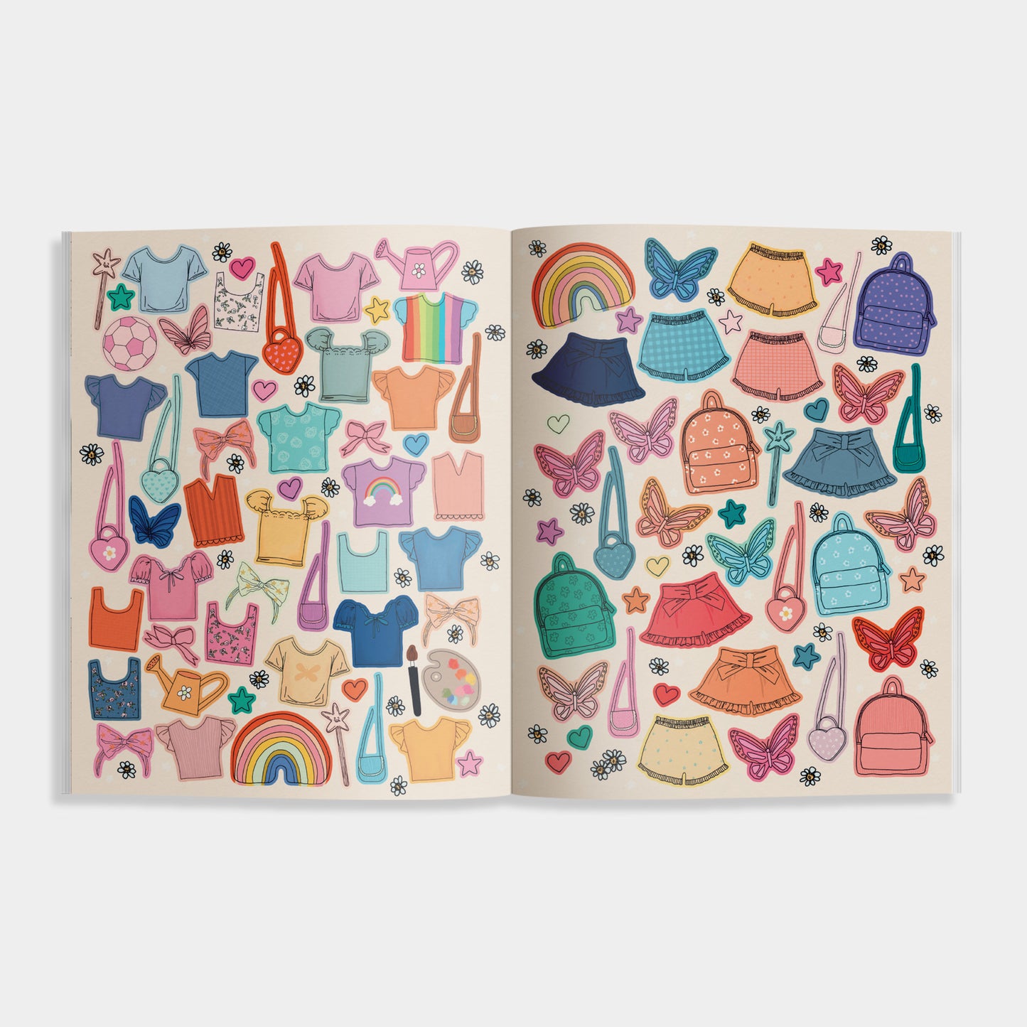Interior spread from “My Sticker Storybook: Fairies & Unicorns” featuring colorful dress-up stickers, including tops, skirts, purses, backpacks, butterflies, and rainbows on a soft gray background