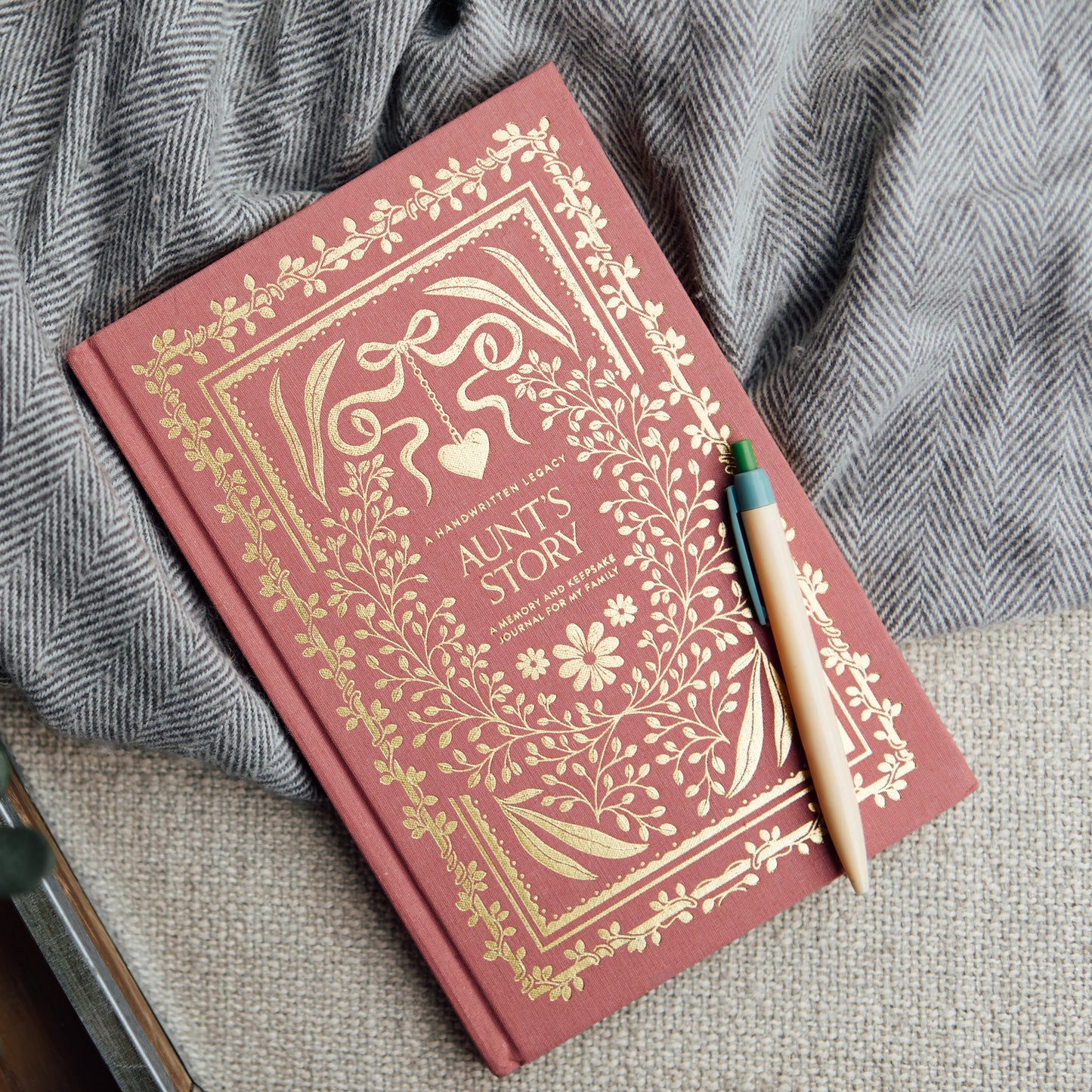Decorative red book 'Aunt's Story' with gold embossed text on a textured surface