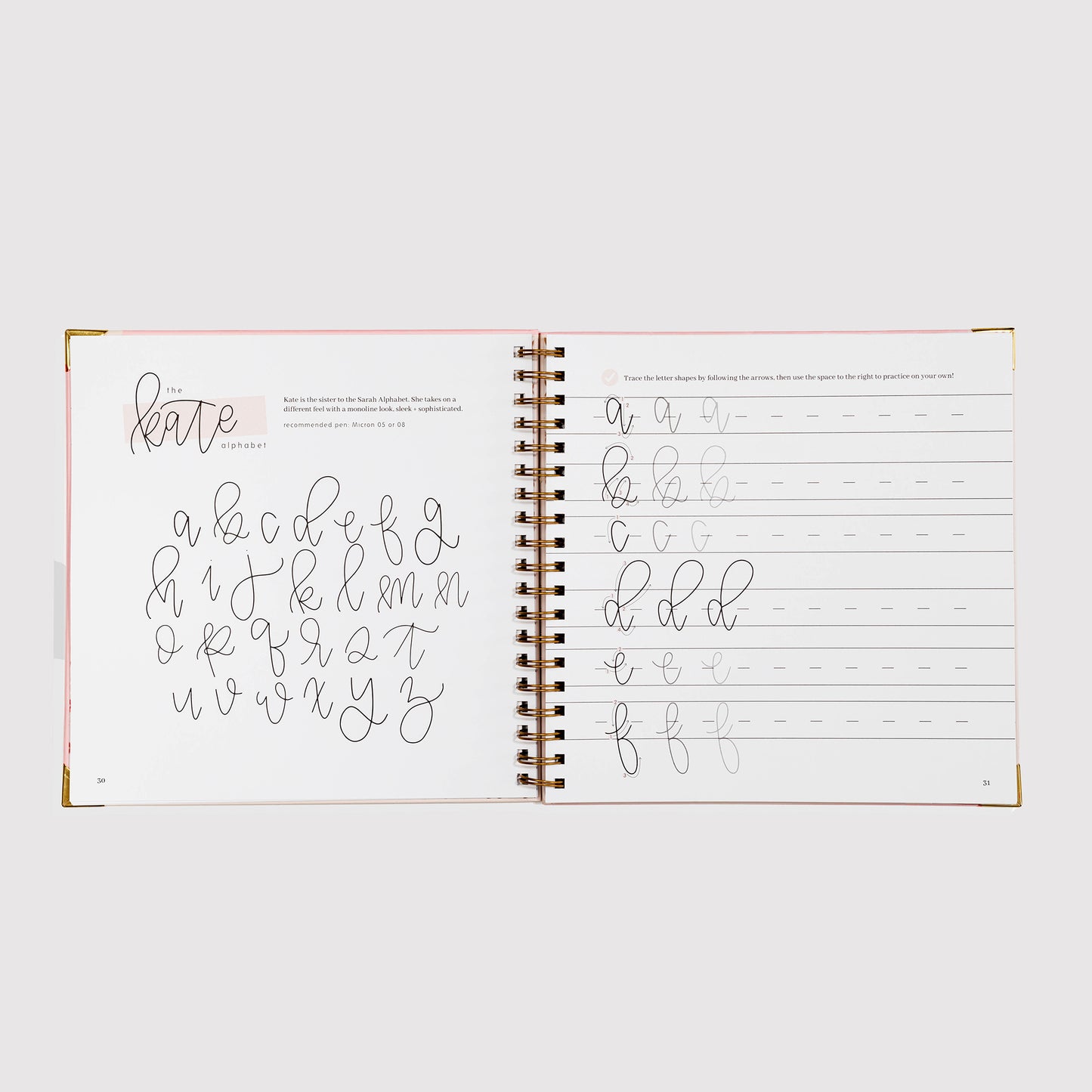 Open notebook with handwriting practice pages on a white background