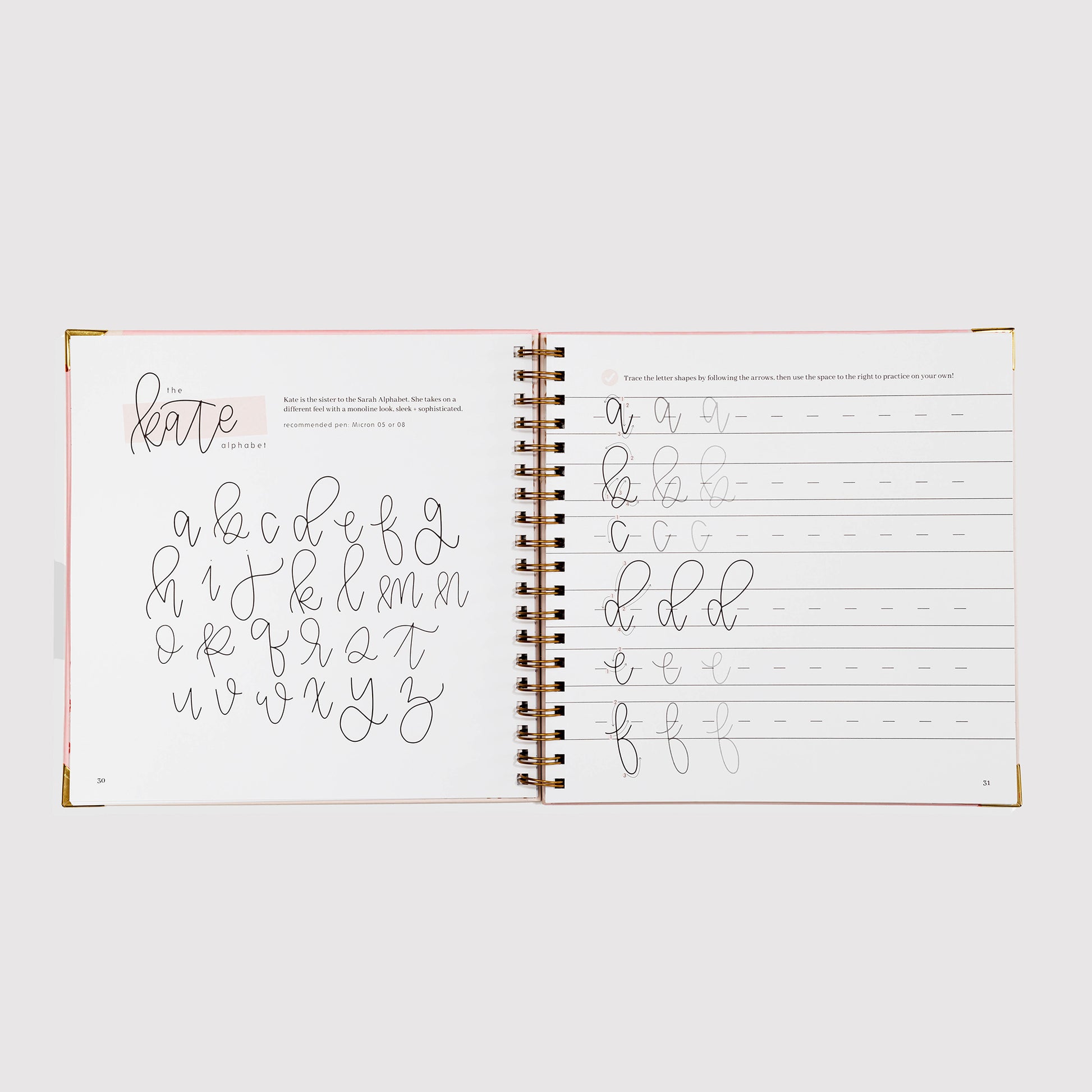 Open notebook with handwriting practice pages on a white background