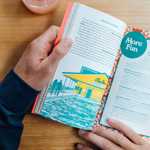 A person holding Nashville Book of Dates inside view showing "Moon River" 