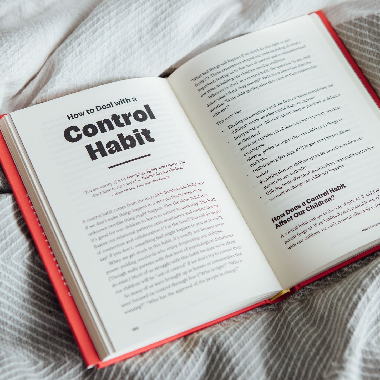 Open book on a textured surface with text visible