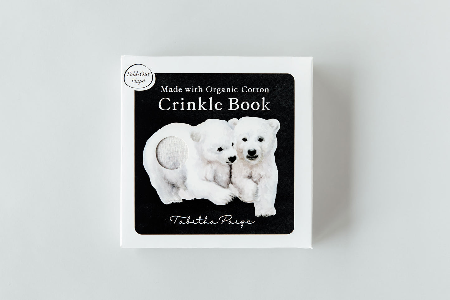 Cradle book with polar bear illustration on a light gray background