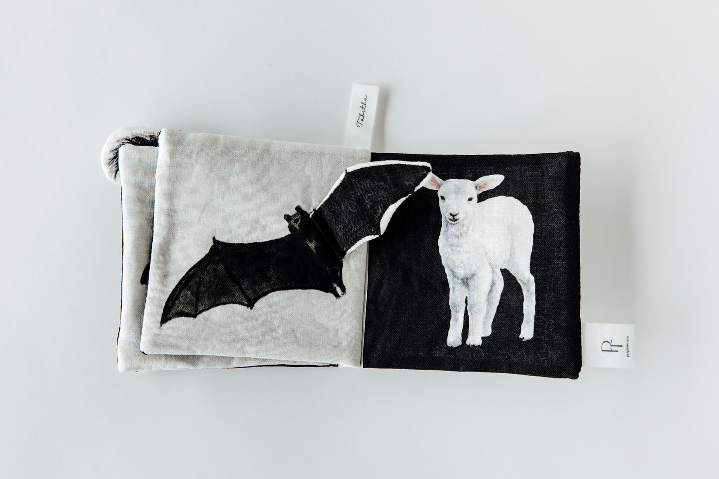 Two pouches with bat and lamb designs on a white background