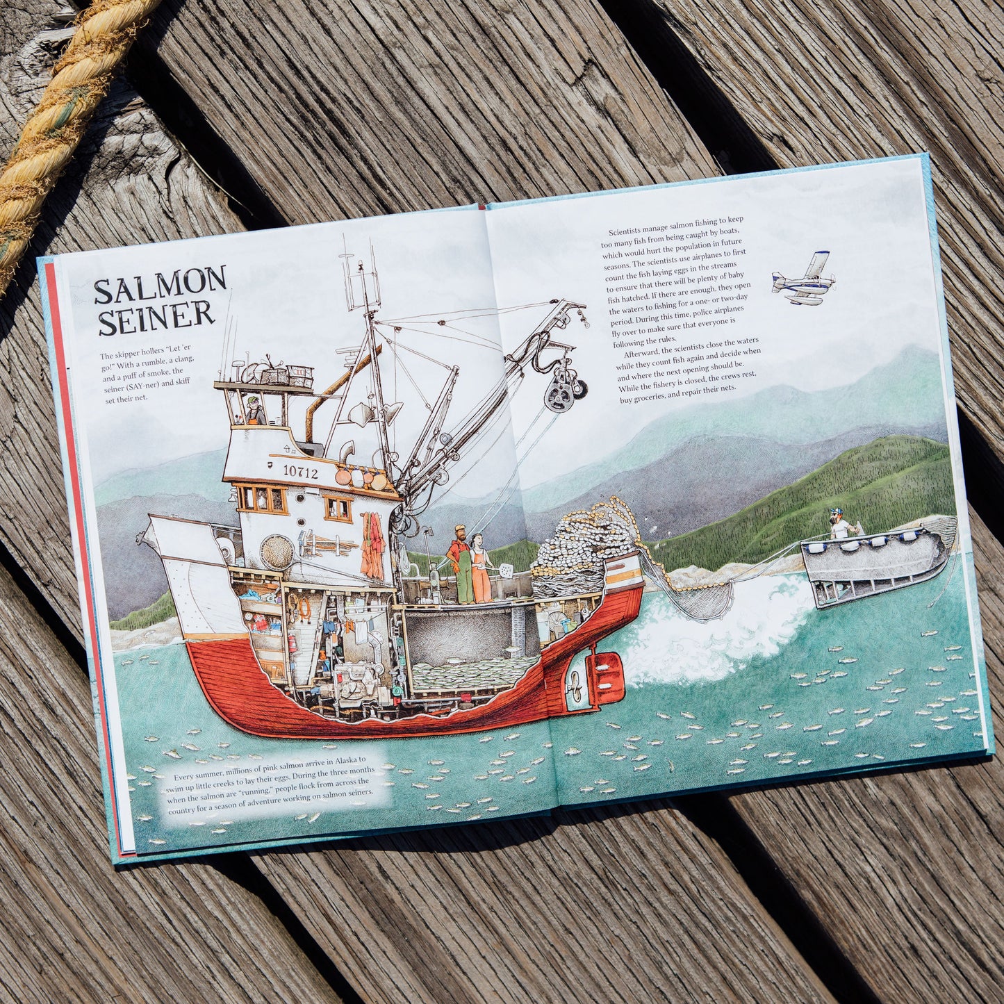 Booklet about a salmon seiner on a wooden surface with rope