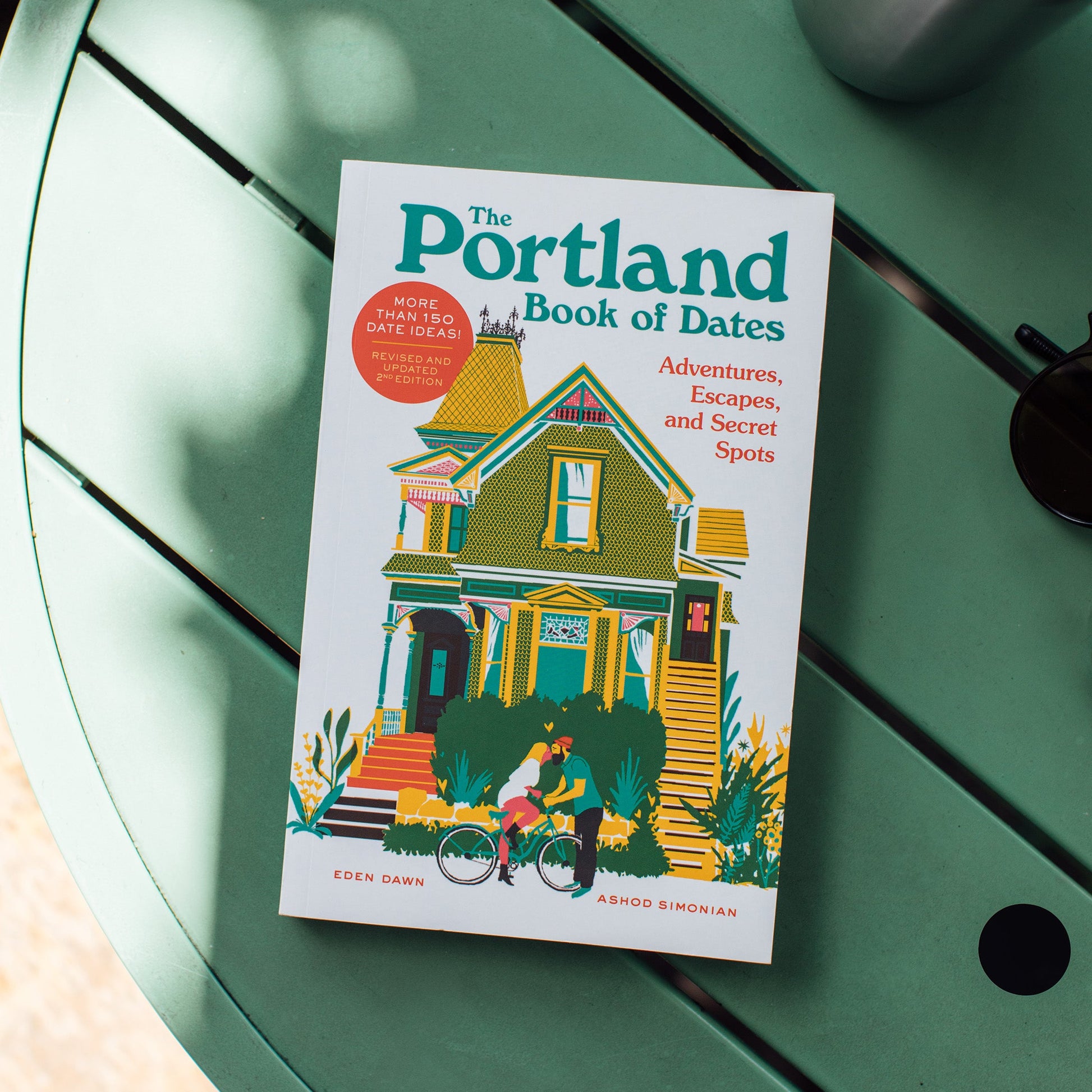 Book titled 'The Portland Book of Dates' on a green surface