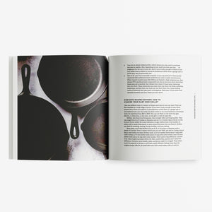 Open book showing a page with silhouettes of kitchen utensils and another with text.