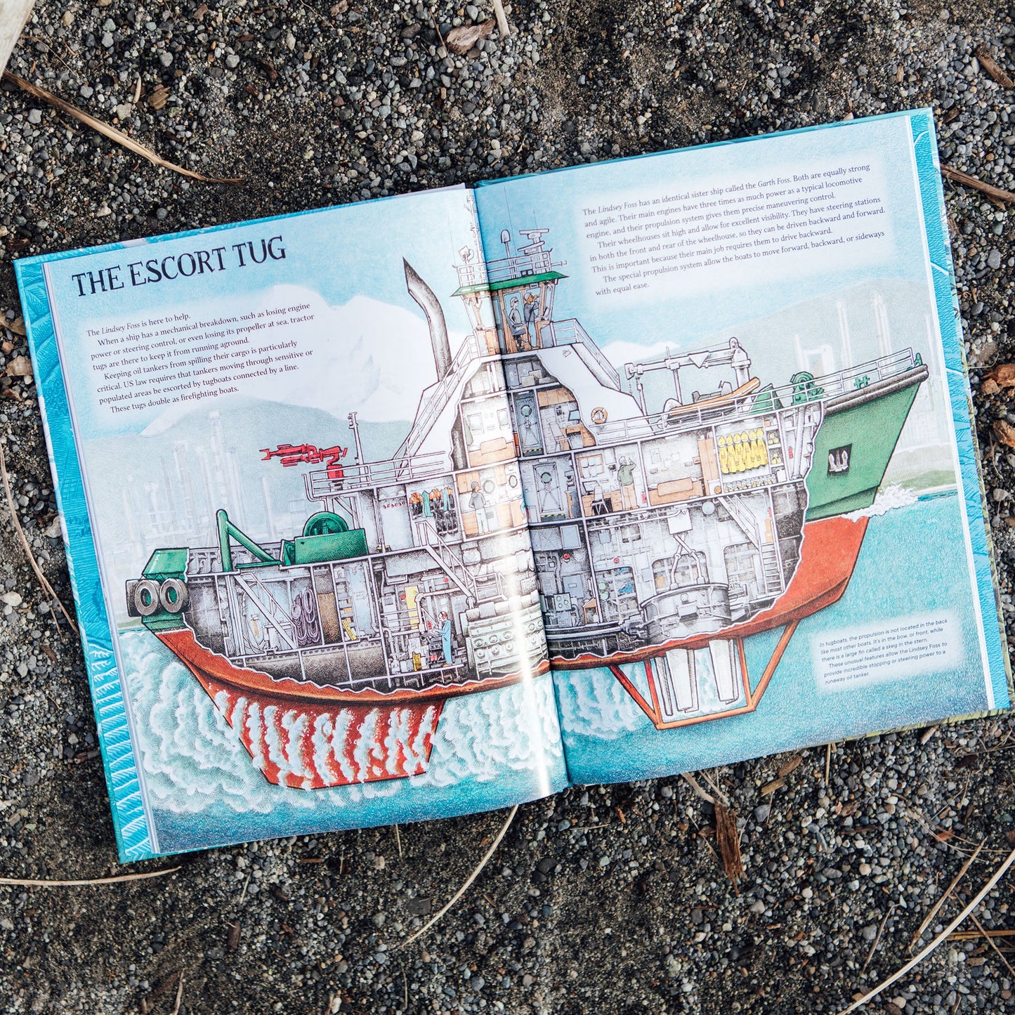 Book open to a page with an illustration of a ship on a textured surface