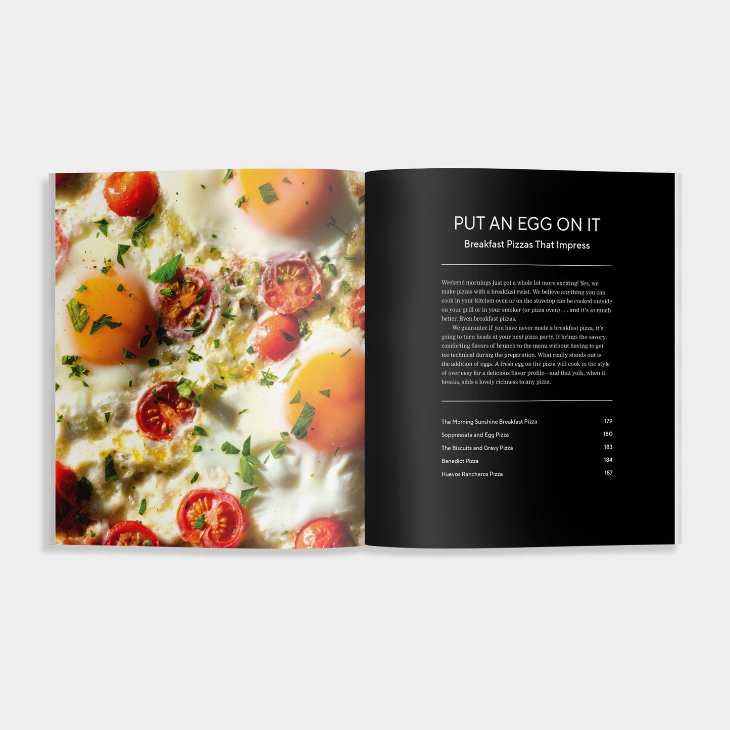 Open cookbook showing a pizza with eggs and tomatoes on a white background