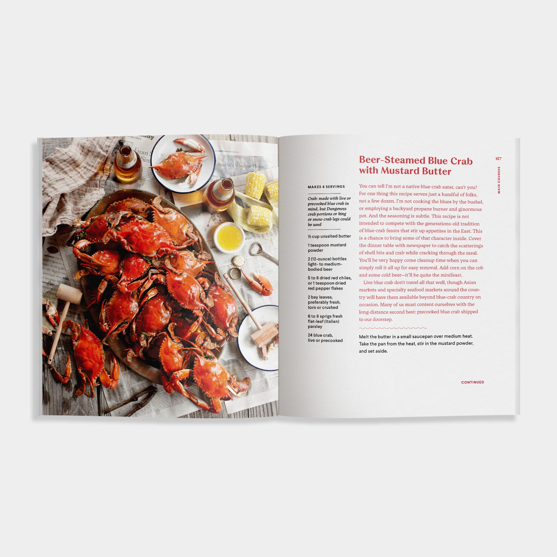 Open cookbook of 'Crab' showing a recipe for Beer-Steamed Blue Crab with Mustard Butter