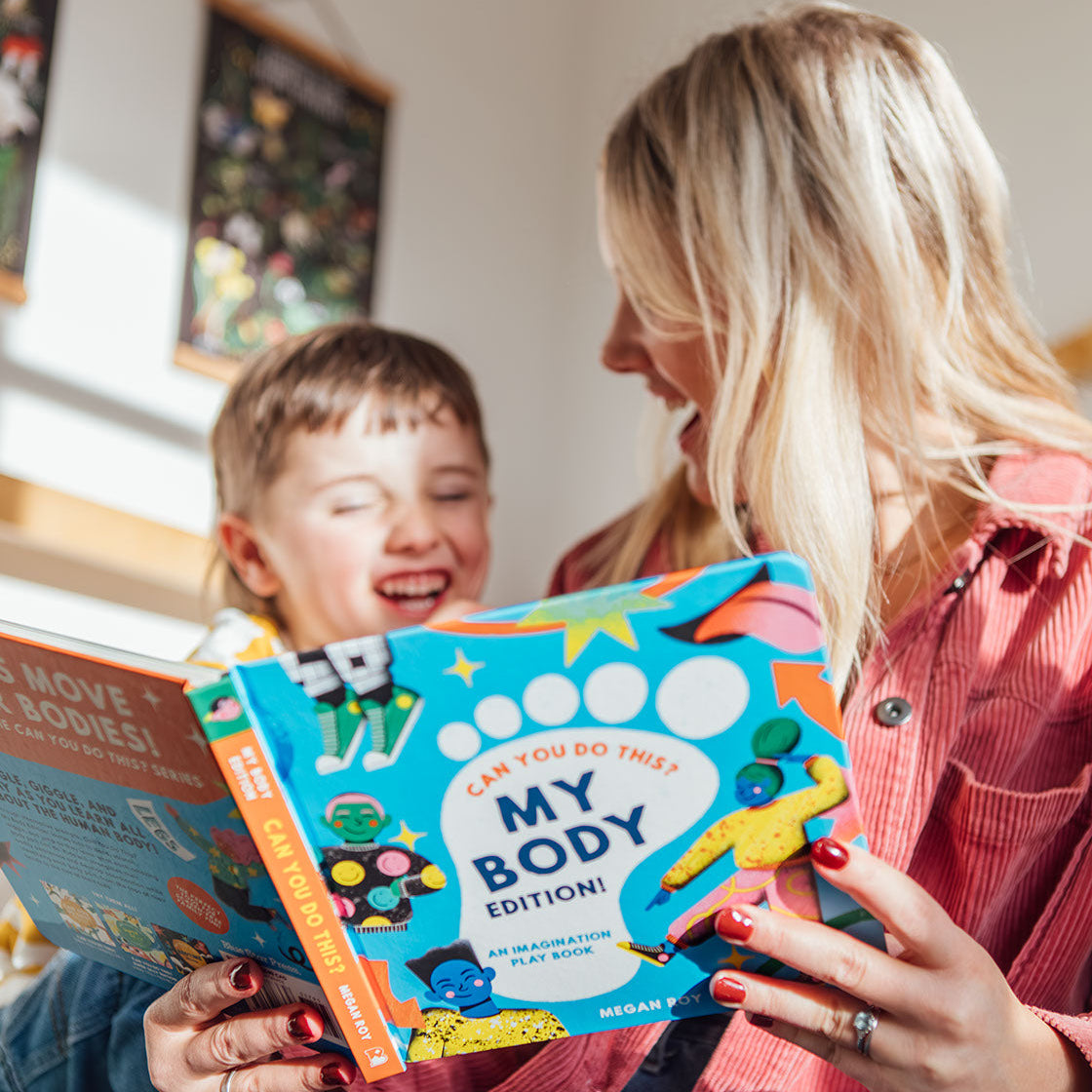 Woman and child reading a book together in a home setting