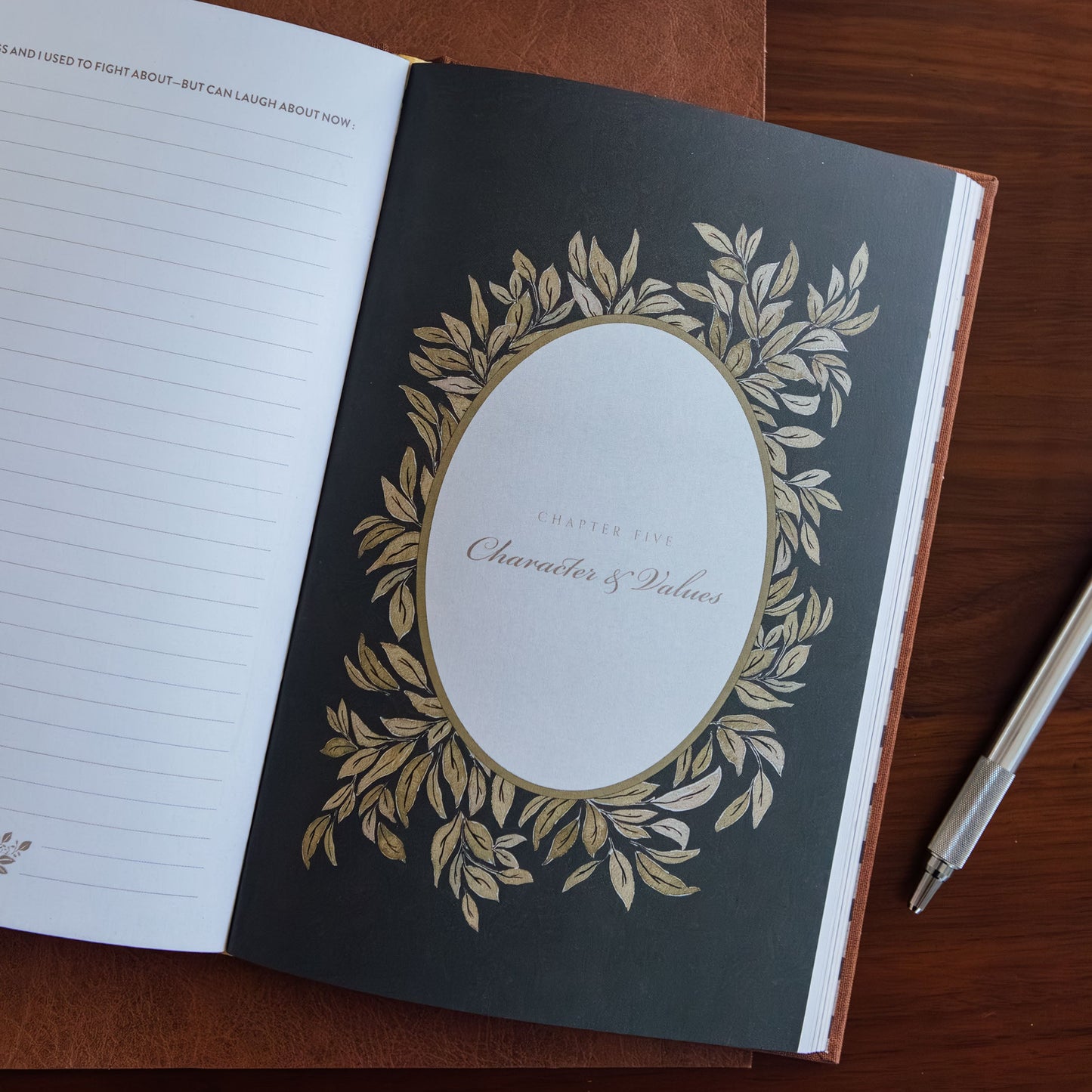 Open notebook with decorative cover on a wooden surface
