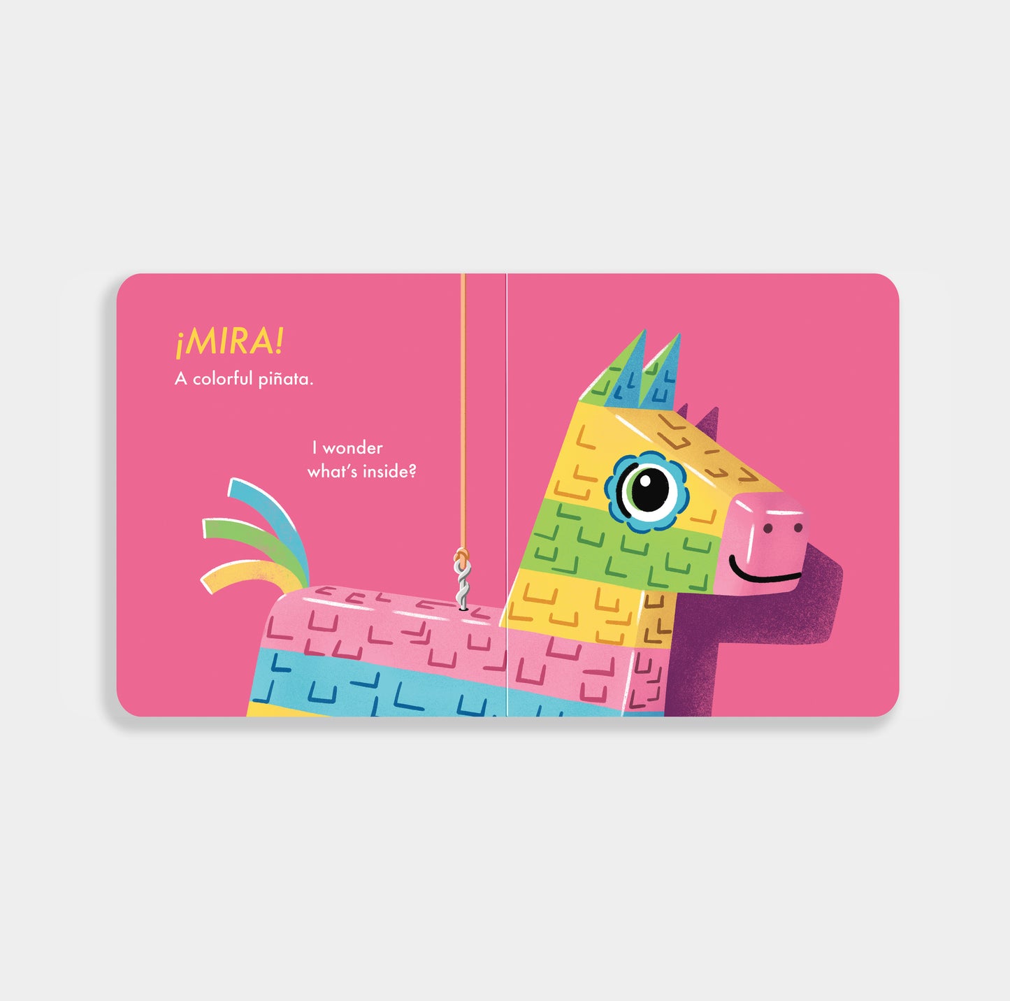 The Unbreakable Piñata a bilingual board book showing a bright pink page with a piñata on it with text in both English and Spanish
