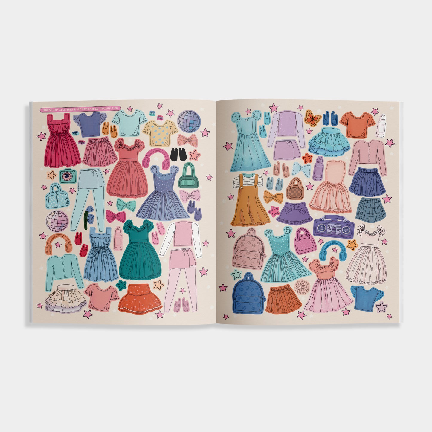 Open book with colorful paper dress illustrations on a white background