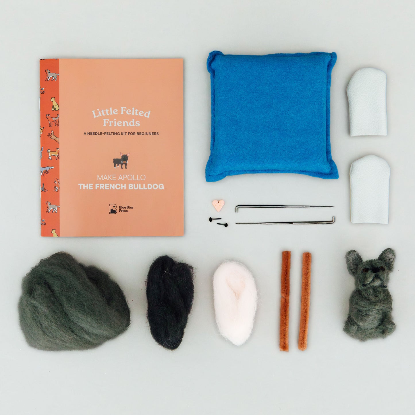 Collection of dog grooming tools and products on a white background